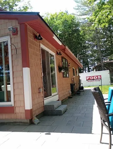 Finished maroon cedar siding and exterior trim beside a paved walkway
