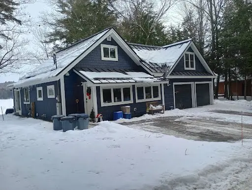 Wide view of completed dark-sided garage and home exterior