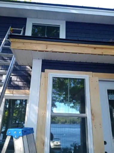 Close view of window trim during dark exterior siding installation